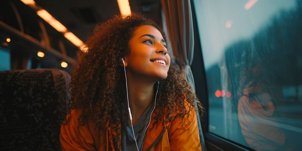 Young girl travelling by bus looking out the window